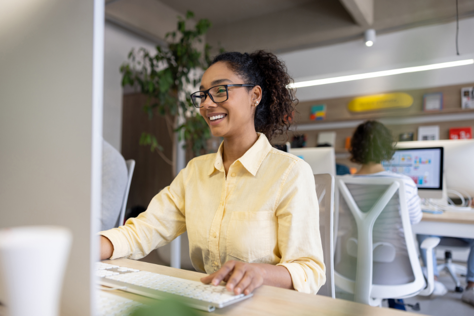 A lady sat at her desk working. How hot desking can improve your mental health.